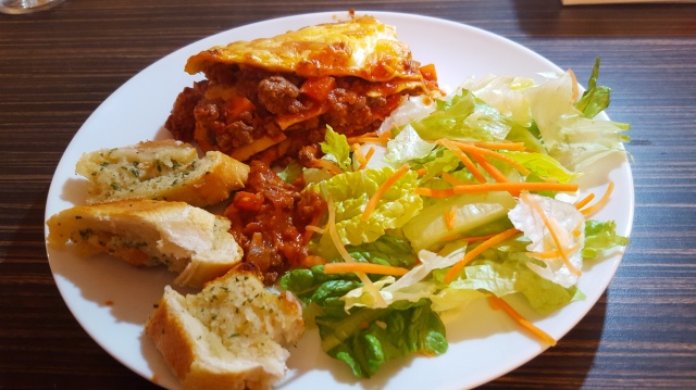 Lasagne served with salad and garlic bread